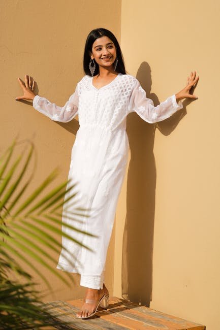 Stylish woman in a white chikankari kurti outdoors, showcasing ethnic elegance.