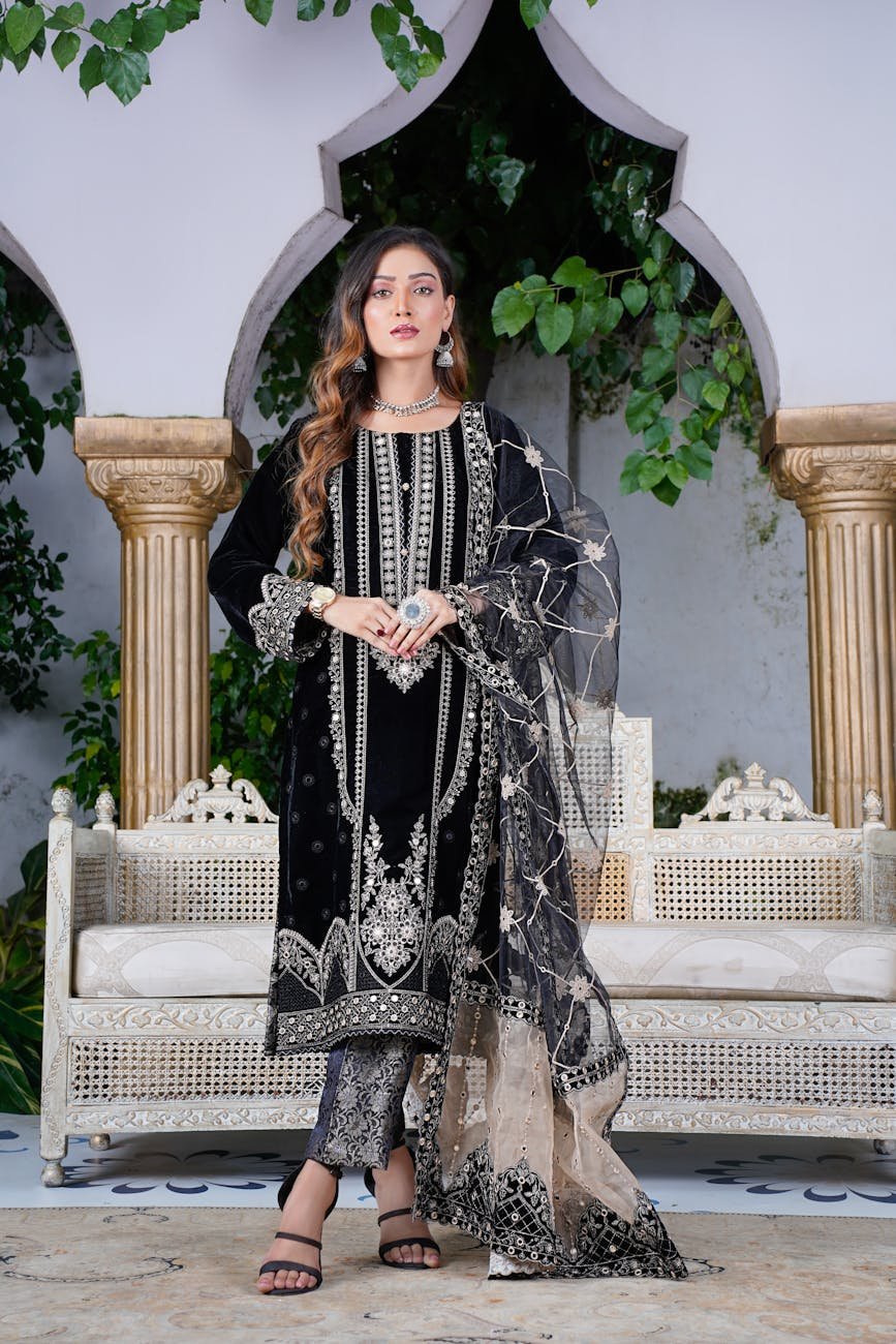 Traditional Pakistani fashion portrait featuring ornate embroidered dress.