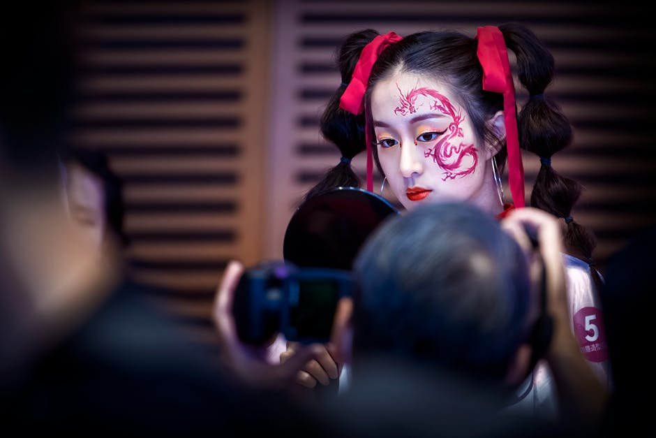A woman with red dragon face paint at a cultural event, captured with vibrant colors and intricate makeup detail.